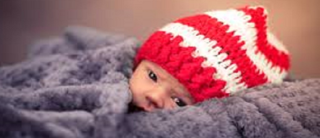 baby with bonnet and blanket